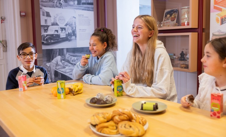 Barn och unga som äter tillsammans i matsäcksrummet